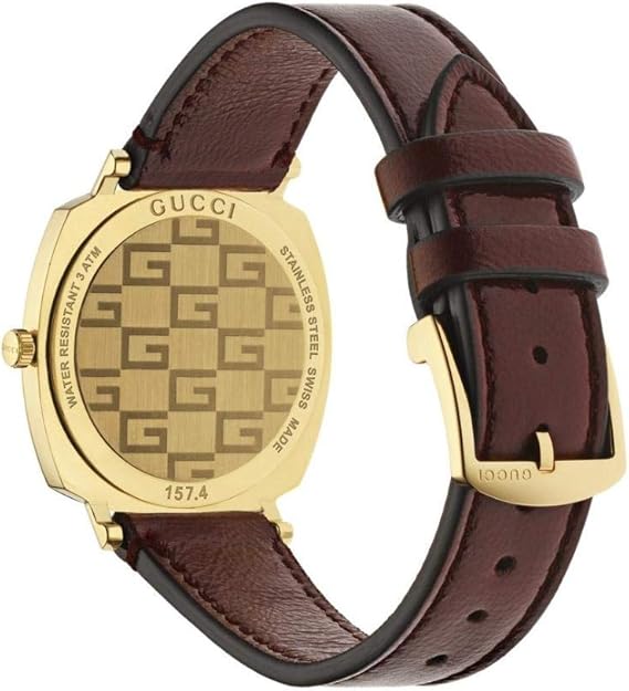Caseback detail of Gucci Grip watch showing gold-tone case with GG monogram pattern and model reference