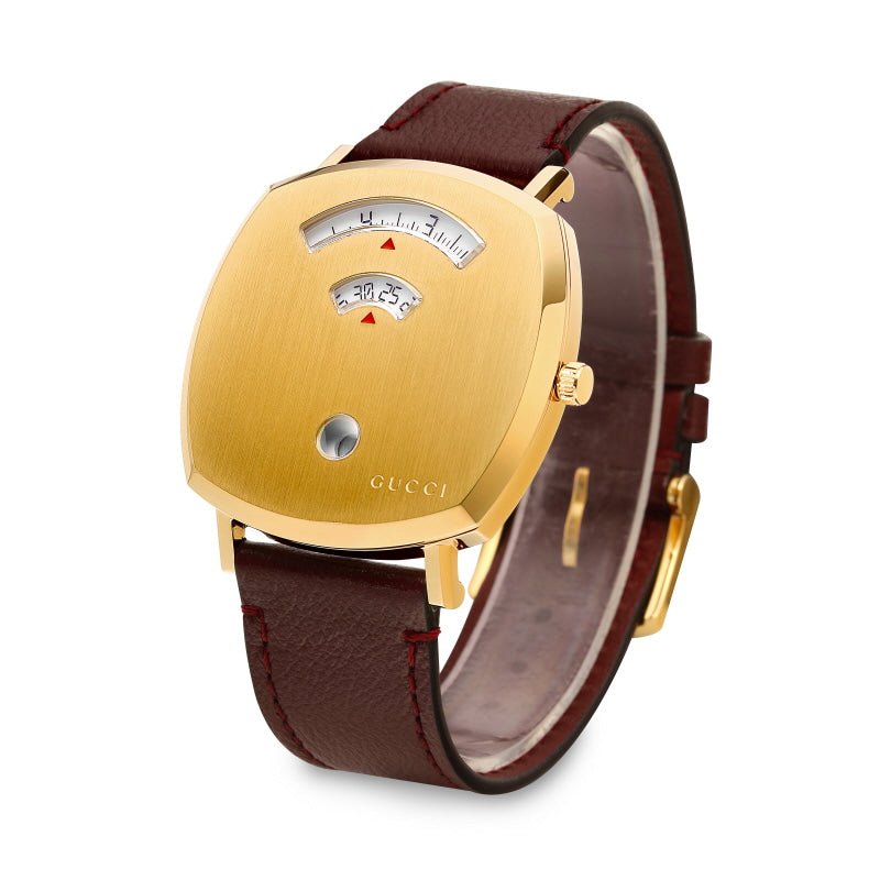 Gucci Grip watch displayed on wrist showing gold case with dual dials and burgundy leather strap