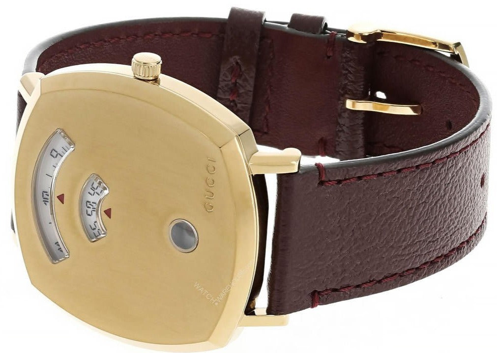 GUCCI Grip 38MM yellow gold watch on wrist with bordeaux leather strap and buckle closure