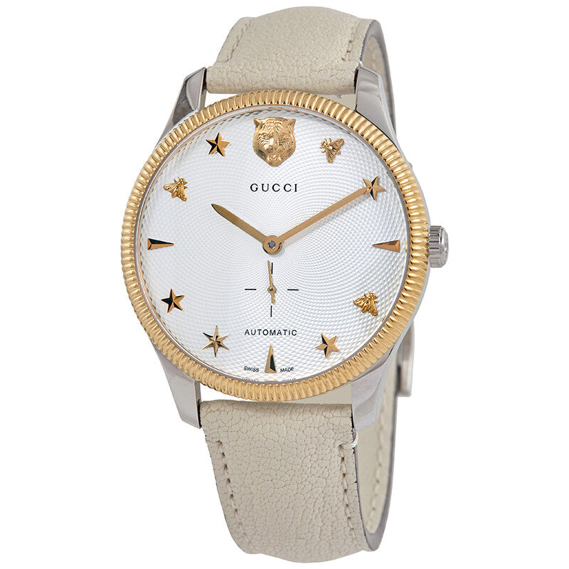 Gucci G-Timeless automatic watch with silver dial, gold bezel, and cream leather strap