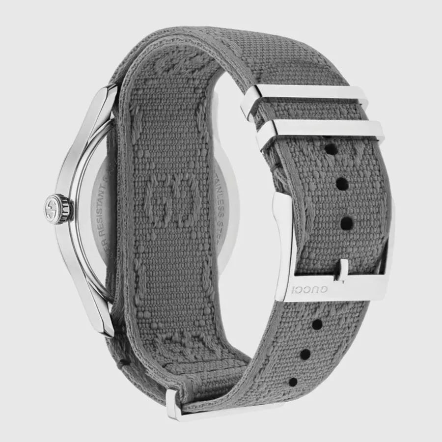 Gucci G-Timeless watch side view showing gray fabric strap with white metal elements