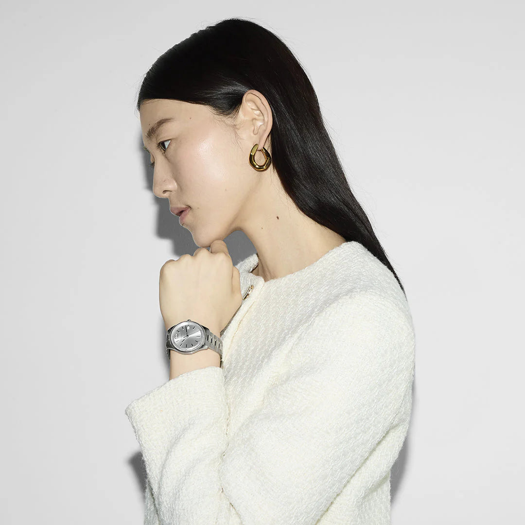 G-Timeless watch on wrist showing silver-tone case and dial detail