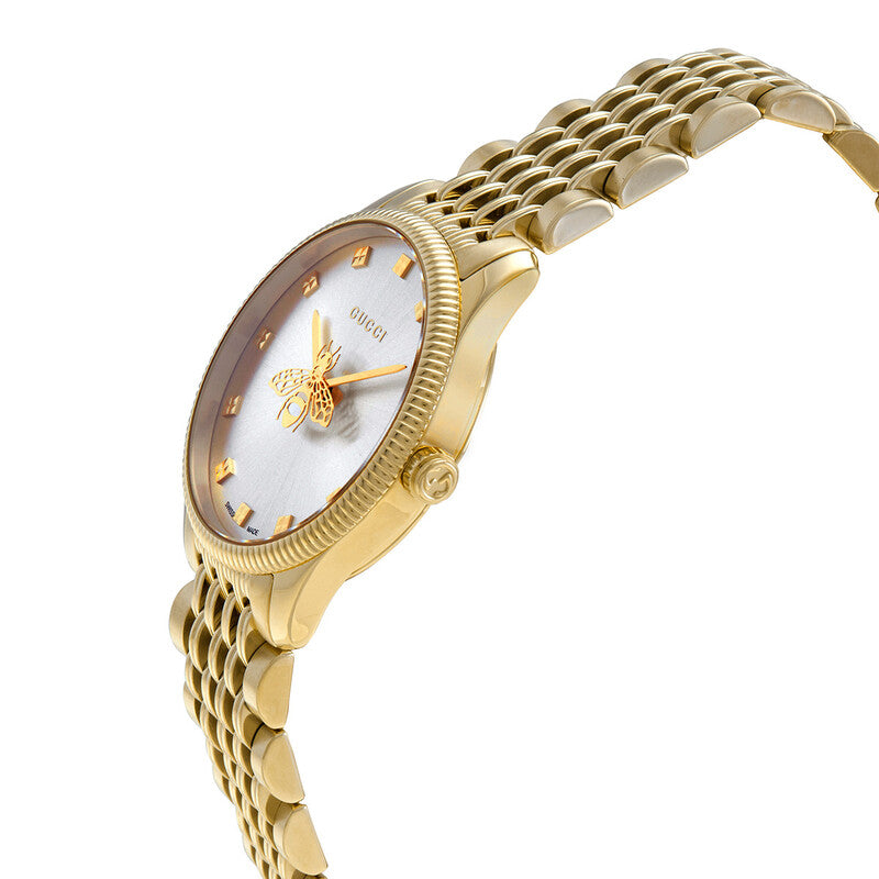 Side angle view of Gucci G-Timeless watch showing gold case, silver dial, and bracelet strap