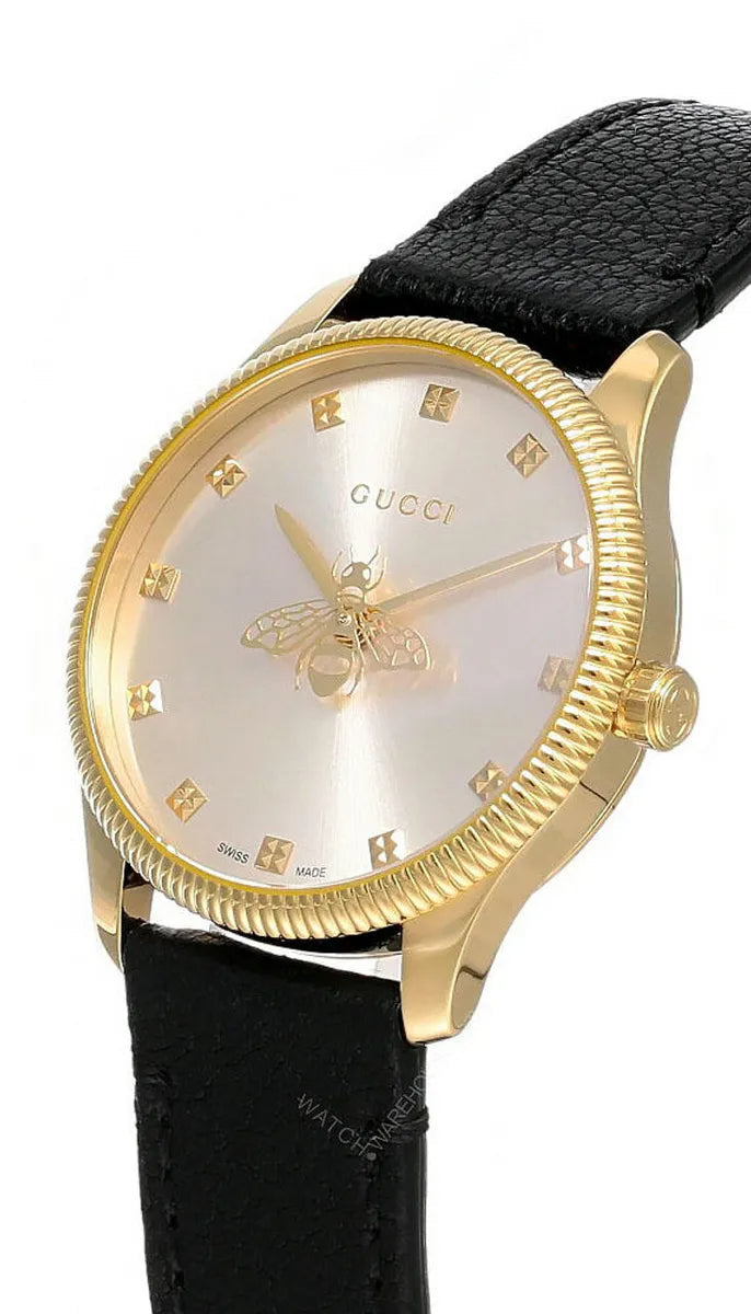 Angled view of Gucci G-Timeless watch showing silver dial with gold Gucci bee and hour markers