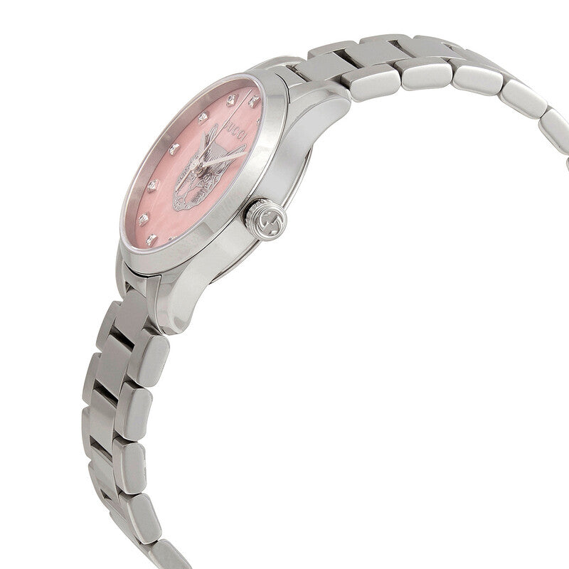 Gucci G-Timeless watch angled view showing pink dial with winged logo and stainless steel bracelet