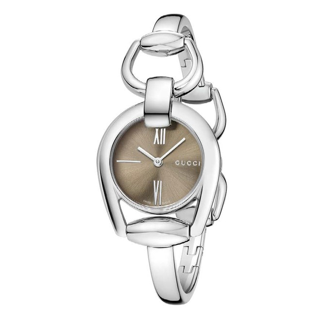 Gucci Horsebit watch on wrist showing brown dial and silver horsebit buckle design