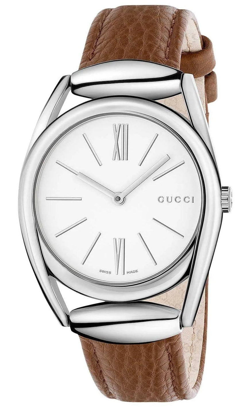 Gucci Horsebit 34mm womens watch with white dial, brown leather strap, and steel case on wrist