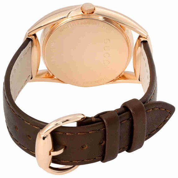 Case back of Gucci Horsebit watch showing rose gold case with engraved details and brown leather strap with buckle