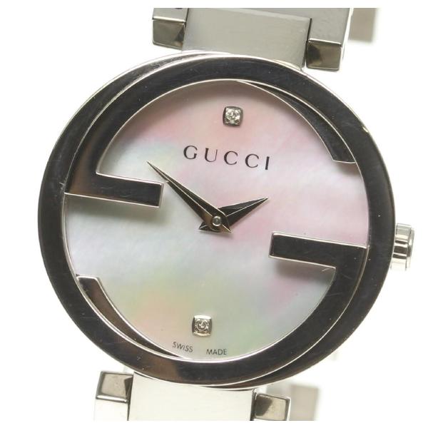 Close-up of Gucci watch dial with pink mother-of-pearl, interlocking GG markers, and hand indices