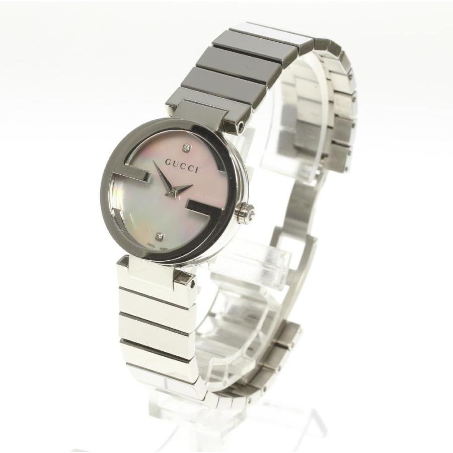 Gucci Interlocking dress watch on wrist showing stainless steel interlocking bracelet
