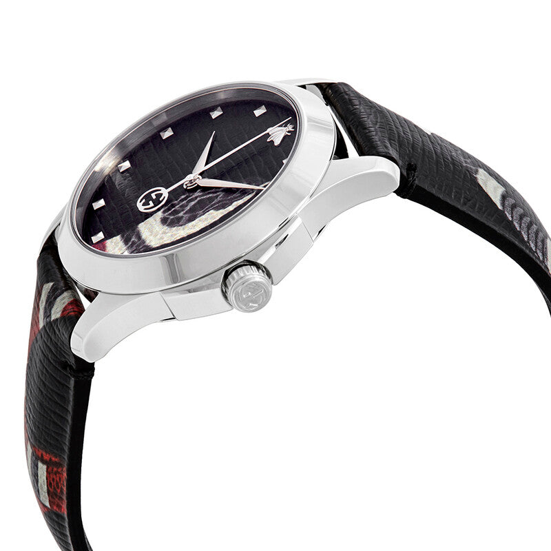 Side angle view of Gucci Le Marche Des Merveilles watch with stainless steel case and patterned leather strap