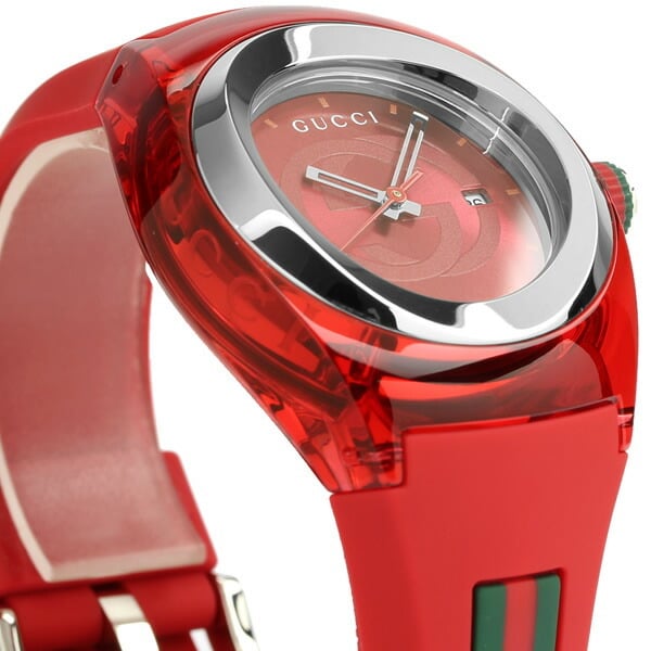 Gucci Sync XXL dial detail with red face, white hands, GG logo, and date window