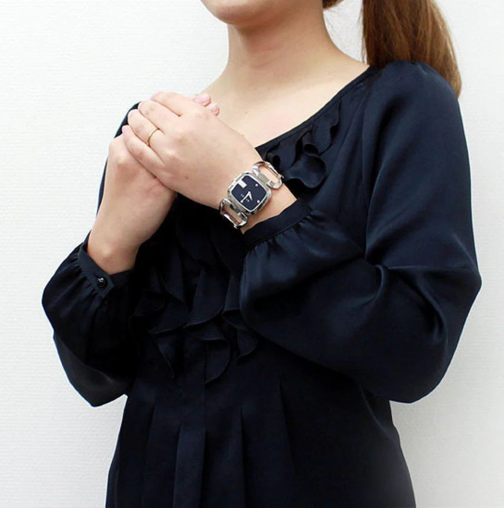 Gucci G-Gucci watch worn on wrist showing black dial and silver link bracelet