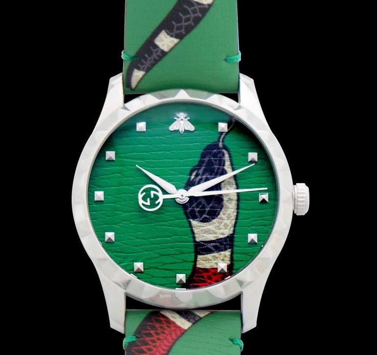 Gucci Le Marche Des Merveilles watch with white case and green kingsnake dial on black background