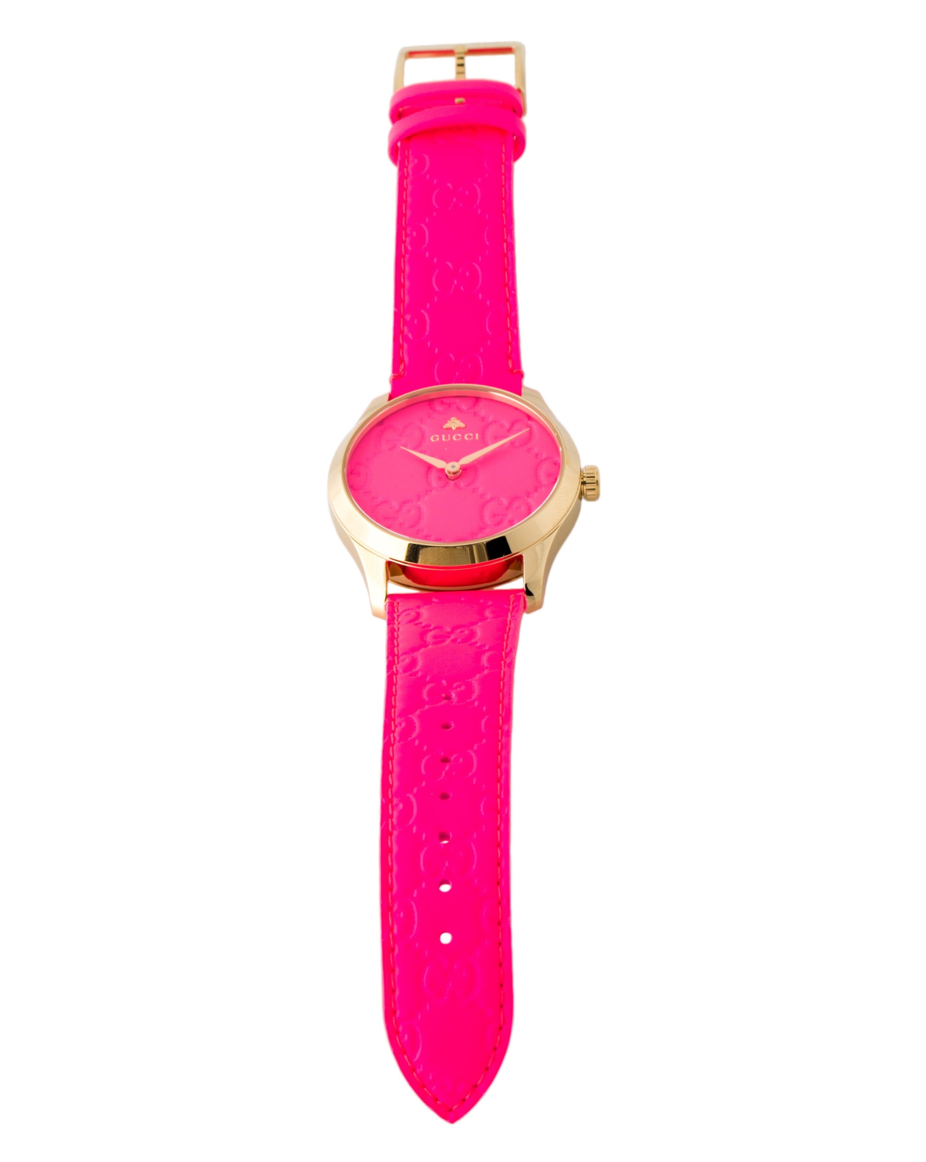 Gucci G Timeless watch on wrist with pink embossed leather strap displayed