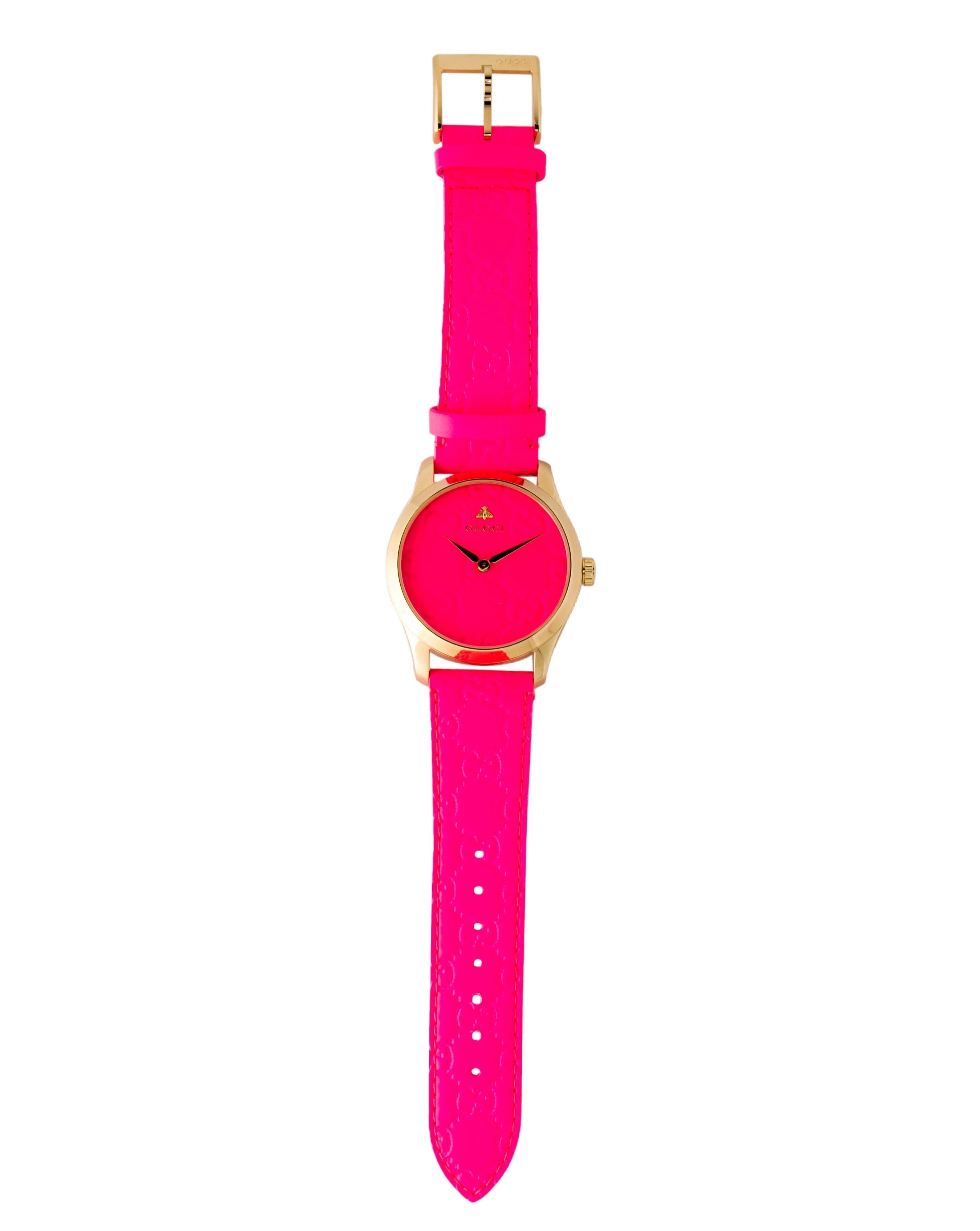 Gucci G Timeless watch worn on wrist showing pink leather strap and buckle