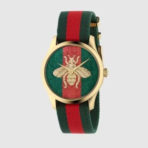 G-Timeless 38mm watch displayed flat with gold case and green-red striped nylon strap