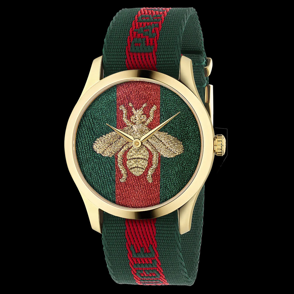 G-Timeless 38mm watch front view with gold case, embroidered bee motif on green and red fabric dial