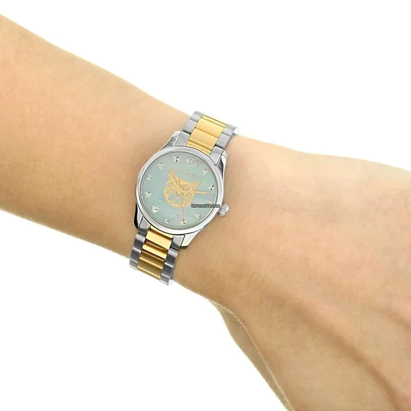 Gucci YA1265011 G-Timeless watch worn on wrist showing blue dial with gold cat
