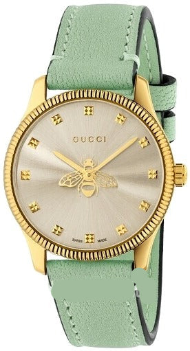 Gucci G-Timeless yellow gold PVD watch with silver dial, bee motif, and green leather strap