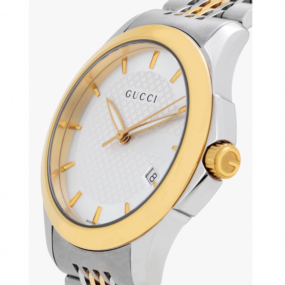 Close-up detail of Gucci G Timeless dial with silver finish and gold hour markers