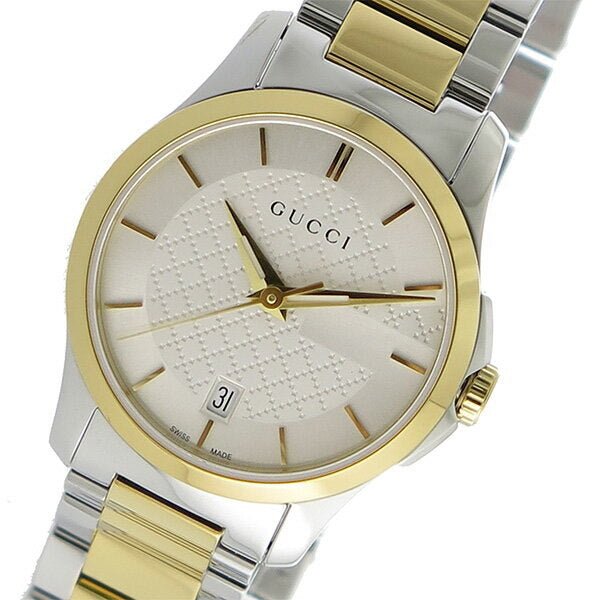 Gucci G-Timeless watch showing silver dial with GG motif and gold-tone bezel