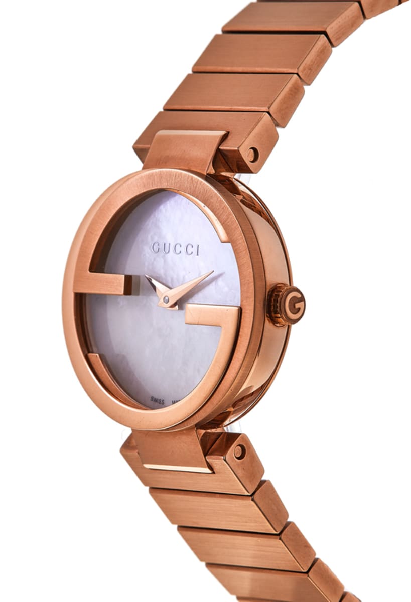 Rose gold Gucci watch with mother of pearl dial and rose gold bracelet at angle