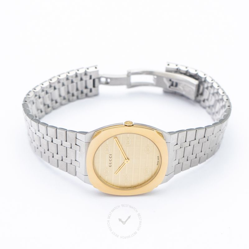 Gucci 25H quartz watch worn on wrist, showing brass dial and stainless steel bracelet