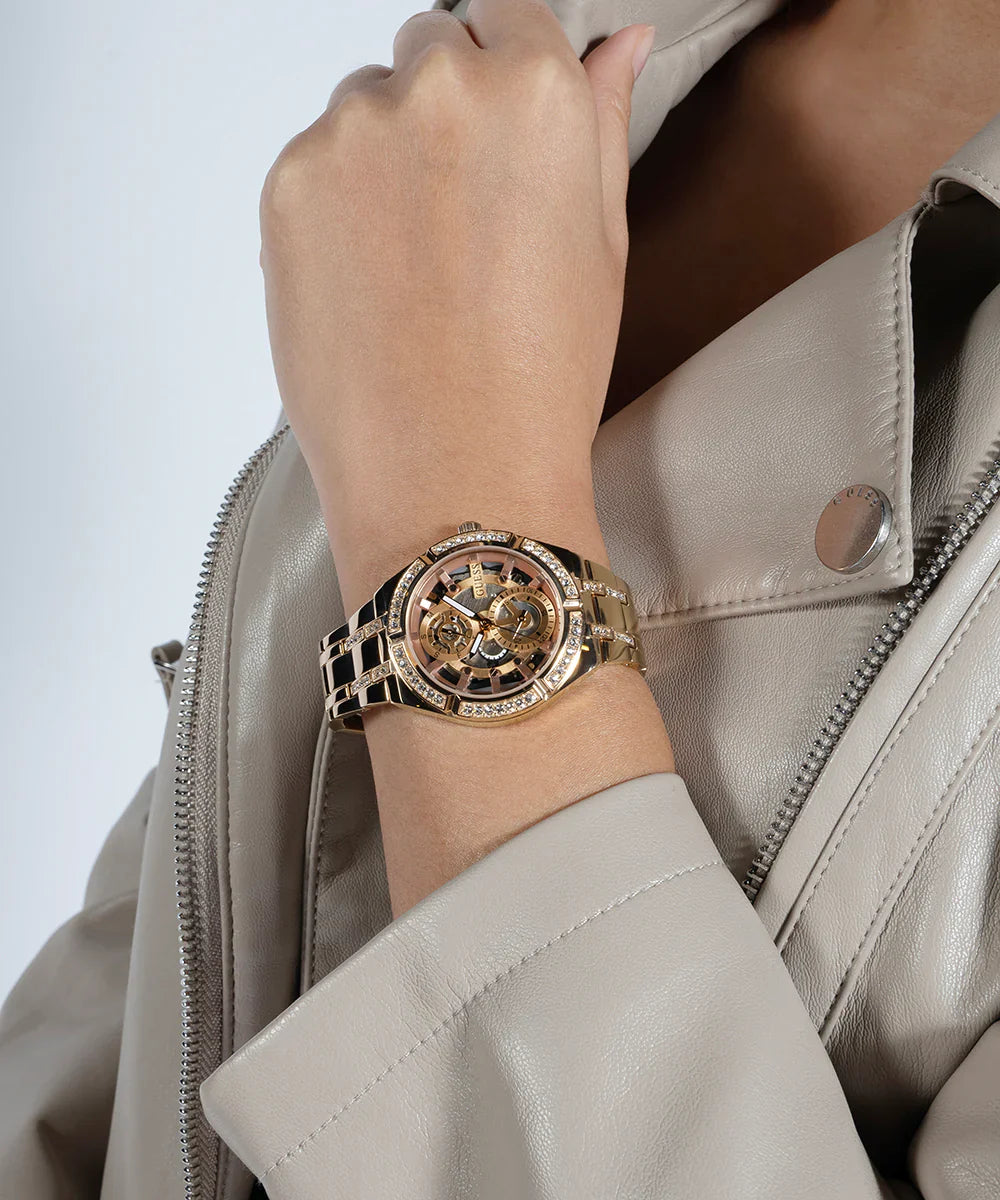 Guess Allara rose gold watch worn on wrist with skeleton dial visible