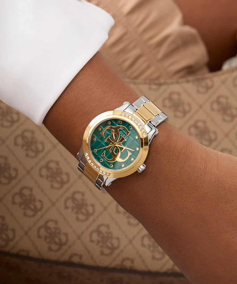 Guess Annette 36mm ladies watch worn on wrist showing teal dial and two-tone bracelet