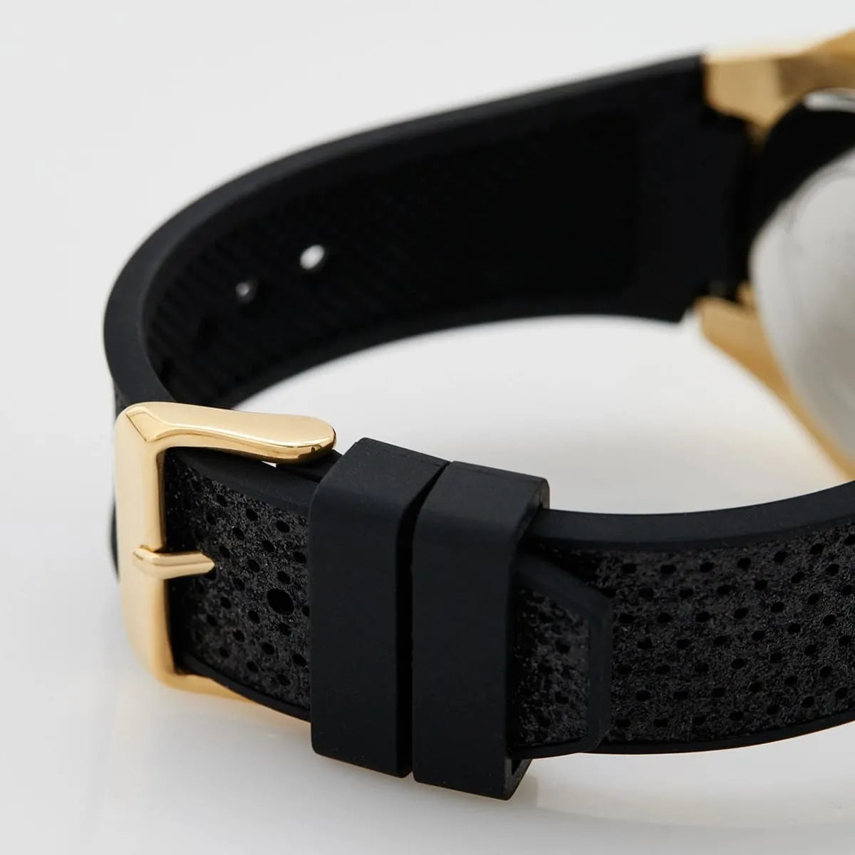 Guess Asteria strap detail showing gold buckle closure and black rubber texture