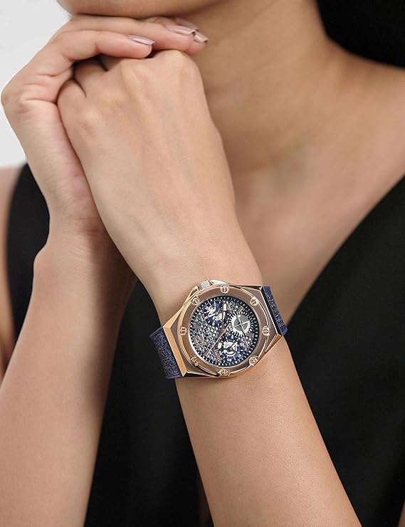 Guess ASTERIA watch worn on wrist showing rose gold case and blue strap