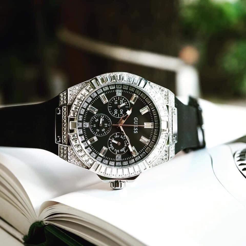 Guess Baguette Crystals watch on wrist with book in background