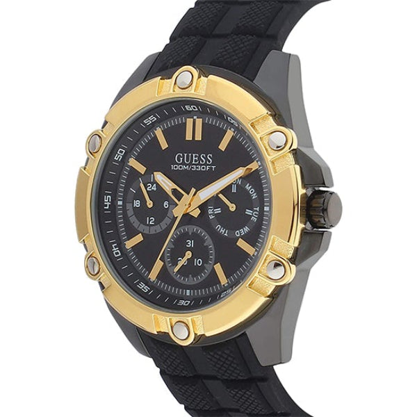 Guess Caliber watch angled view showing gold-tone bezel and black silicone strap detail