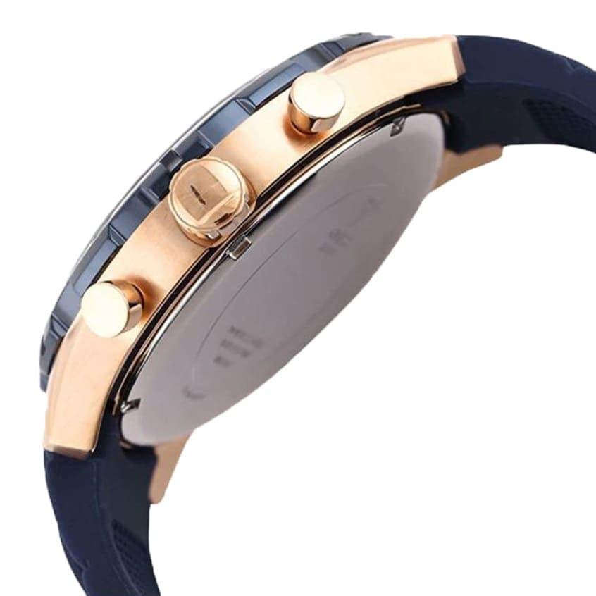 Guess Caliber chronograph watch side view showing rose gold case and blue rubber strap