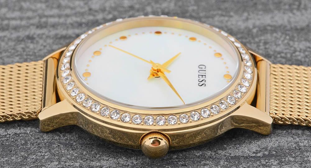 Close-up of Guess Chelsea watch dial showing mother of pearl with gold hour markers