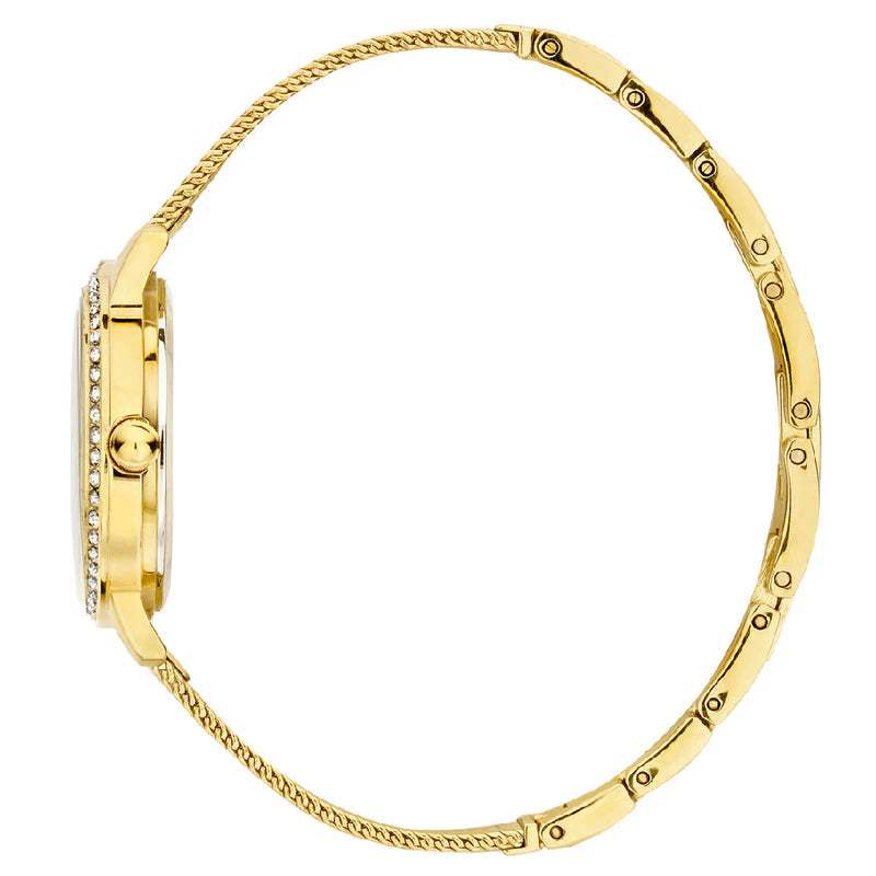 Guess Chelsea gold watch on wrist displaying white dial with crystal bezel
