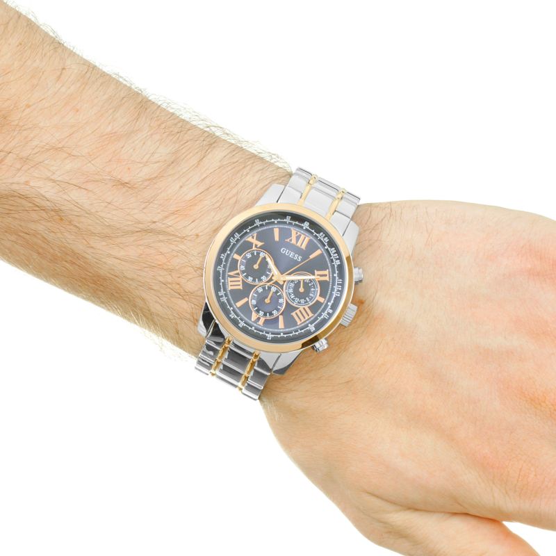 Guess Chrono two-tone watch worn on wrist showing blue dial with Roman numerals