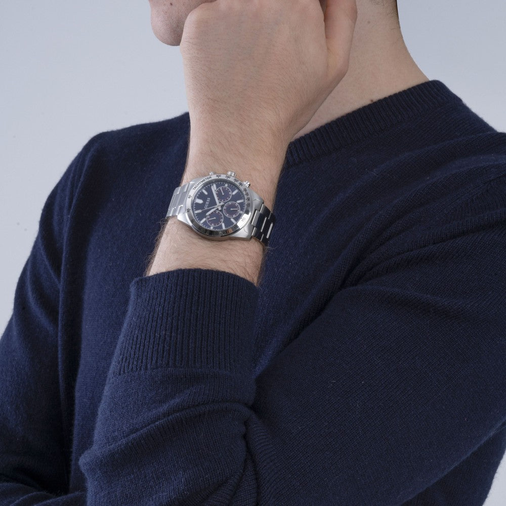 Guess chronograph watch worn on wrist showing silver case and blue dial