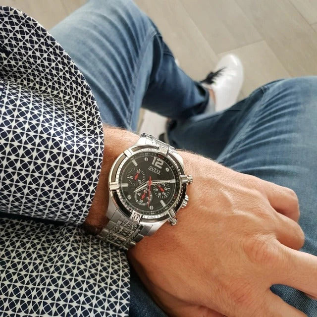 Guess Circuit chronograph worn on wrist showing black dial with silver steel strap