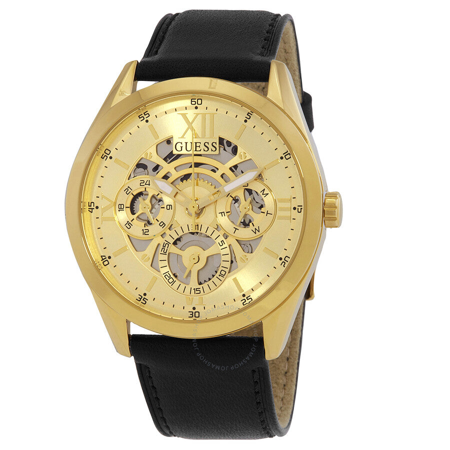 Guess Classic gold-tone skeleton watch with visible gears, black leather strap, and Guess logo on champagne dial
