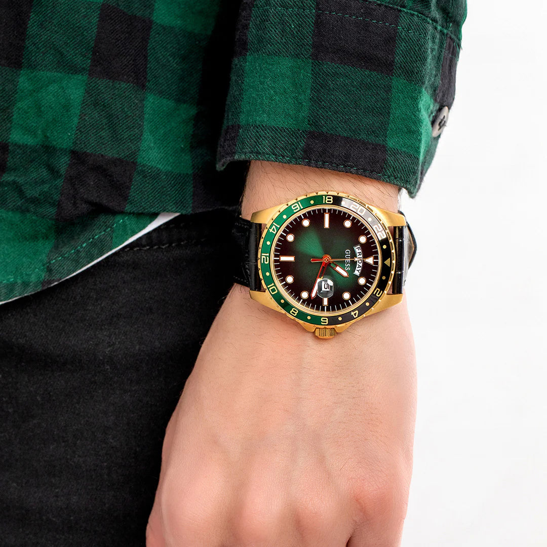 Guess Comet watch worn on wrist with green dial and gold-tone case