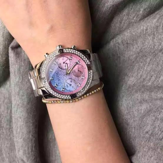 Guess Confetti watch worn on wrist with gradient confetti dial and crystal bezel