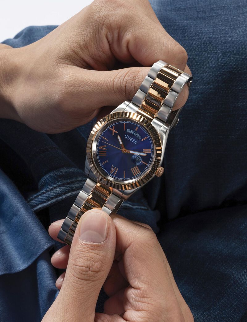 Guess Connoisseur watch on wrist showing bracelet detail and blue dial