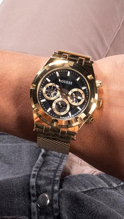 Guess Continental chronograph watch on wrist showing gold case and black dial