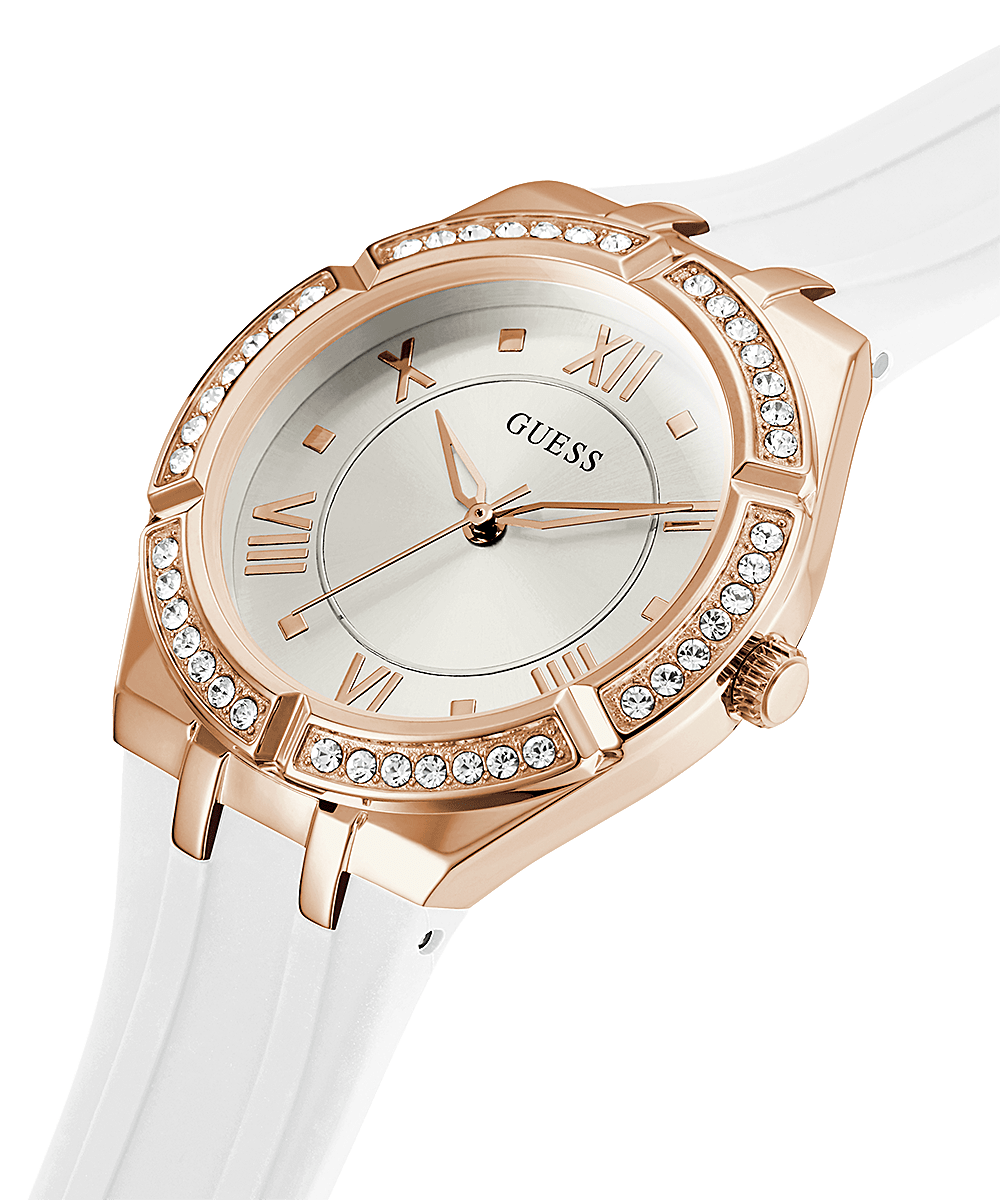 Angled view of Guess Cosmo rose gold watch with white strap and crystal bezel detail