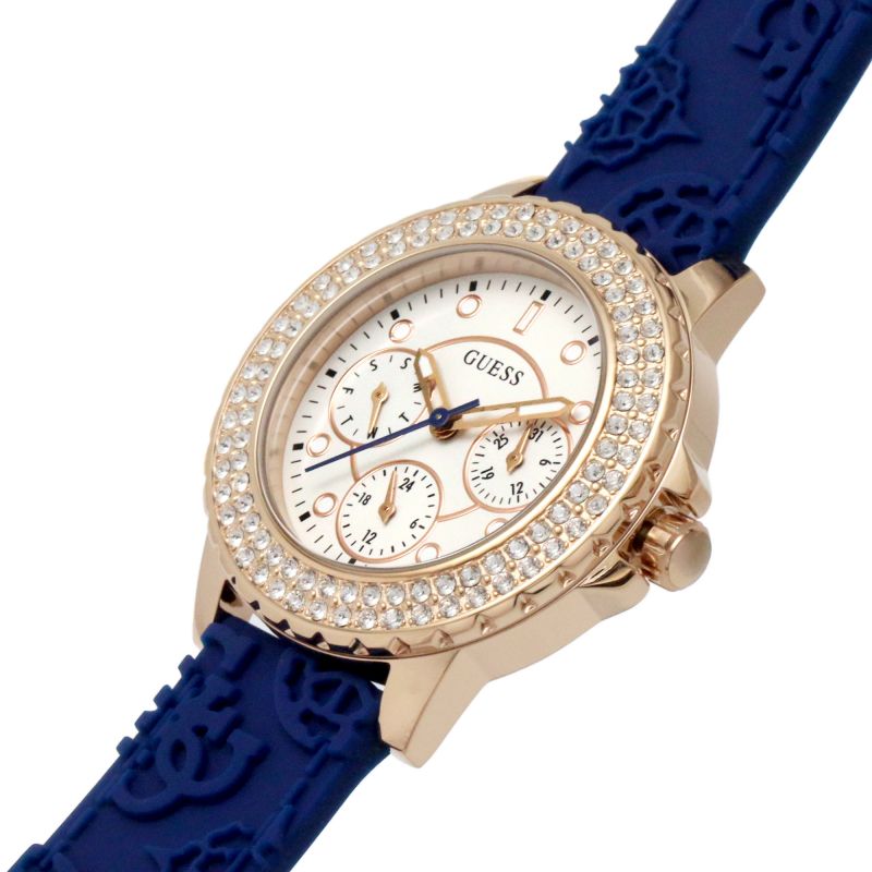 Angled view of Guess Crown Jewel watch showing rose gold case, crystal bezel, and blue silicone strap detail