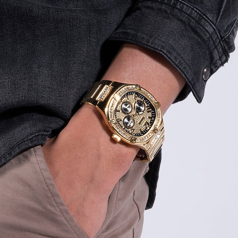 Guess Duke gold chronograph watch worn on wrist with black dial and crystal bezel