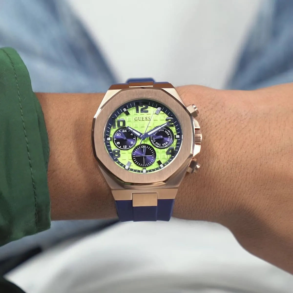 GUESS Empire chronograph watch worn on wrist showing lime green dial and blue strap