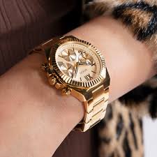 Guess Equality gold chronograph watch worn on wrist